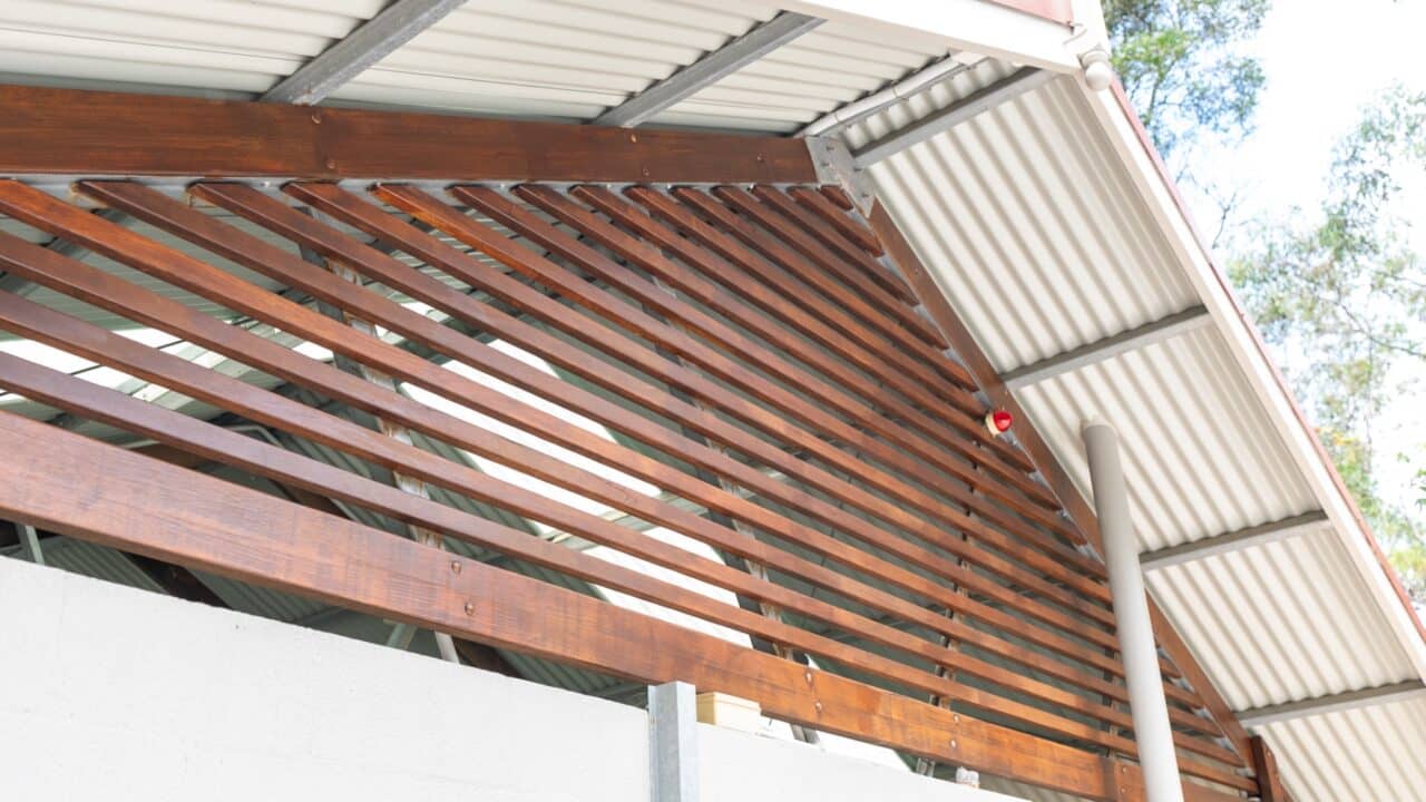 Close-up of an outdoor structure at Wentworth Falls with a metal roof and wooden slats forming a triangular pattern on the side, part of the Lookout Project.